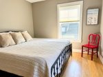 Located on the other side of the Jack and Jill bath, this sunlit bedroom offers a cozy king bed, soft linens, and simple style.