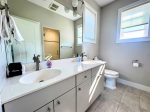 The third-floor king suite includes an en suite bath with dual sinks, natural light, and a walk-in shower designed for easy, spa-like mornings.