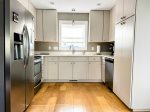 This full kitchen offers stainless appliances, loads of storage, and bright, simple design ideal for easy meals at home.