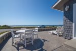 An outdoor table on the oceanfront patio overlooks the Morro Strand Beach