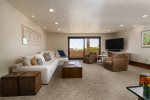 Bonus room serves as a second living room with cozy seating, large flat screen TV, wrap-around balcony access and a queen-size fold out sofa bed