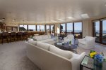 The living room boasts floor to ceiling windows offering gorgeous views of the coastline