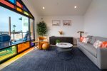 Enjoy light pouring through avant-garde windows in living room and kitchen spaces