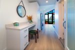 The hallway provides a dedicated working space with desk and charging station