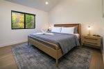 Retreat to the bedroom featuring a king sized bed