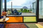 Colorful windows frame the gorgeous view of Morro Rock and the harbor from your living room