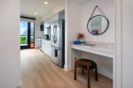 The hallway provides a dedicated working space with desk and charging station