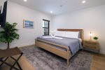 Retreat to the bedroom featuring a king sized bed
