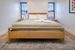 Retreat to the bedroom featuring a king sized bed