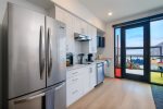 Kitchen includes full-size fridge, microwave, electric double burner, Keurig, and dishwasher