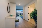 The hallway provides a dedicated working space with desk and charging station