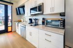 Kitchen includes full-size fridge, microwave, electric double burner, toaster oven, Keurig, and dishwasher