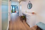 The hallway provides a dedicated working space with desk and charging station