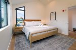Retreat to the bedroom featuring a king sized bed