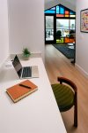 The hallway provides a dedicated working space with desk and charging station