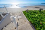 Private stairs from the back deck take you down the sand