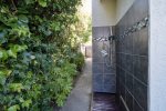 The home has an outdoor shower to wash off sand before entering the home. 