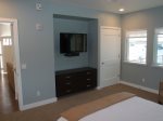 The bedroom has a flat-screen TV, a large dresser and plenty of closet space.
