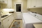 The laundry room has a full sized washer and dryer and sink.  It opens to the back yard