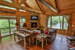 Great room with TV, fireplace and river views