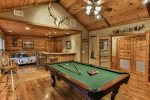 Den with wet bar, pool table and custom stone fireplace 