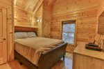 Main level queen master bedroom with TV and private bath