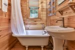 Main level communal bathroom with claw foot tub