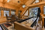 OPen loft game room with shuffleboard and card table 