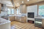 Gourmet Kitchen with Wood Burning Fireplace, Beverage Cooler, 8-gas burner cooktop and range