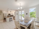 Sunlit dining and kitchen, open and inviting.