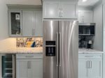 Large french side by side fridge with water dispensers.