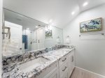 Full bathroom with large mirrors.