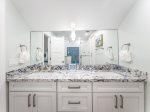 Full bathroom with large mirrors.