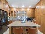 Fully equipped kitchen with a center island for additional seating and surface.