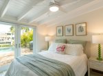 The master suite with a queen bed and direct backyard/pool and bathroom access.