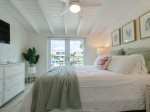 The master suite with a queen bed and direct backyard/pool and bathroom access.