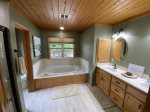Main floor bathroom offers a jetted garden tub and a separate tile shower 