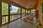 Main floor screen porch with 4 rocking chairs and swing bed