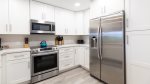 Kitchen with white cabinetry and stainless appliances