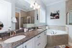 Master bathroom on the ground floor with dual vanity, garden tub, and walk-in shower.