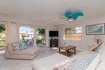 Living area with TV and plenty of lounging & seating