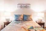 Next to the bathroom is the downstairs bedroom with a comfortable queen bed.