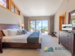 The primary King bedroom has a dresser, sliding door with a full view, an attached walk-in closet, and a full bathroom.