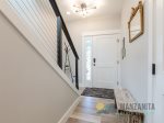 Located outside the bottom-level bedrooms is the main entrance. 