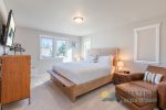 The primary bedroom with a King bed and a TV.