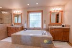 Primary full bathroom with a large soaking tub and walk-in shower.