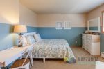 Across the hall from the primary bedroom upstairs is this Queen bedroom.