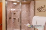 The bathroom has a walk-in shower only.