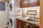The laundry room is downstairs and includes detergent sheets, an iron, and an ironing board.