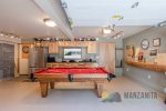 The garage has a pool table and an extra fridge/freezer.
